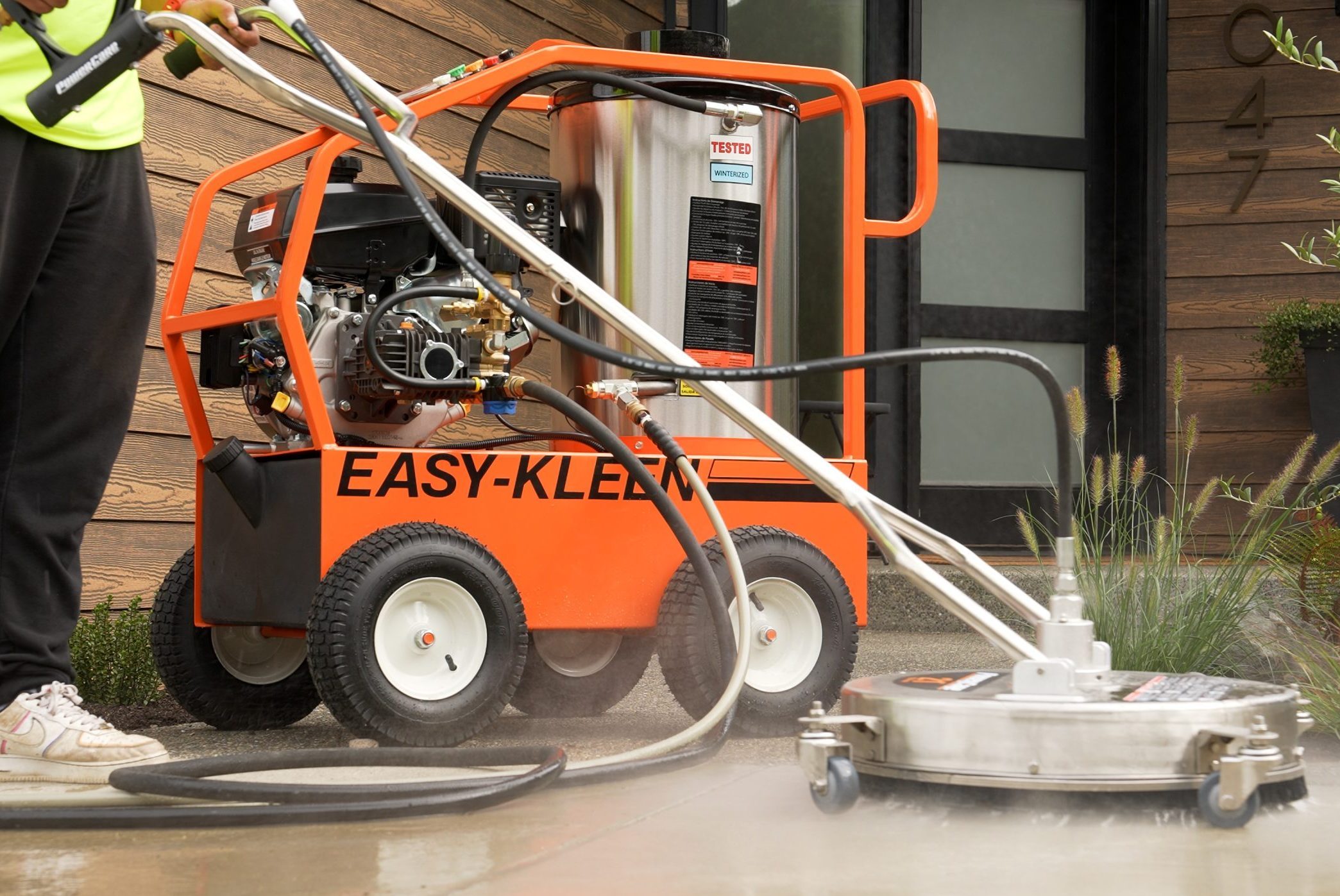 Commercial pressure washer cleaning a building entryway Commercial pressure washer cleaning a building entryway
